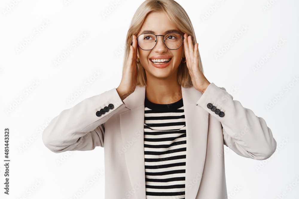 Portrait of smiling beautiful blond girl trying new glasses, picking eyewear, standing over white background Portrait of smiling beautiful blond girl trying new glasses, picking eyewear, standing over white background
