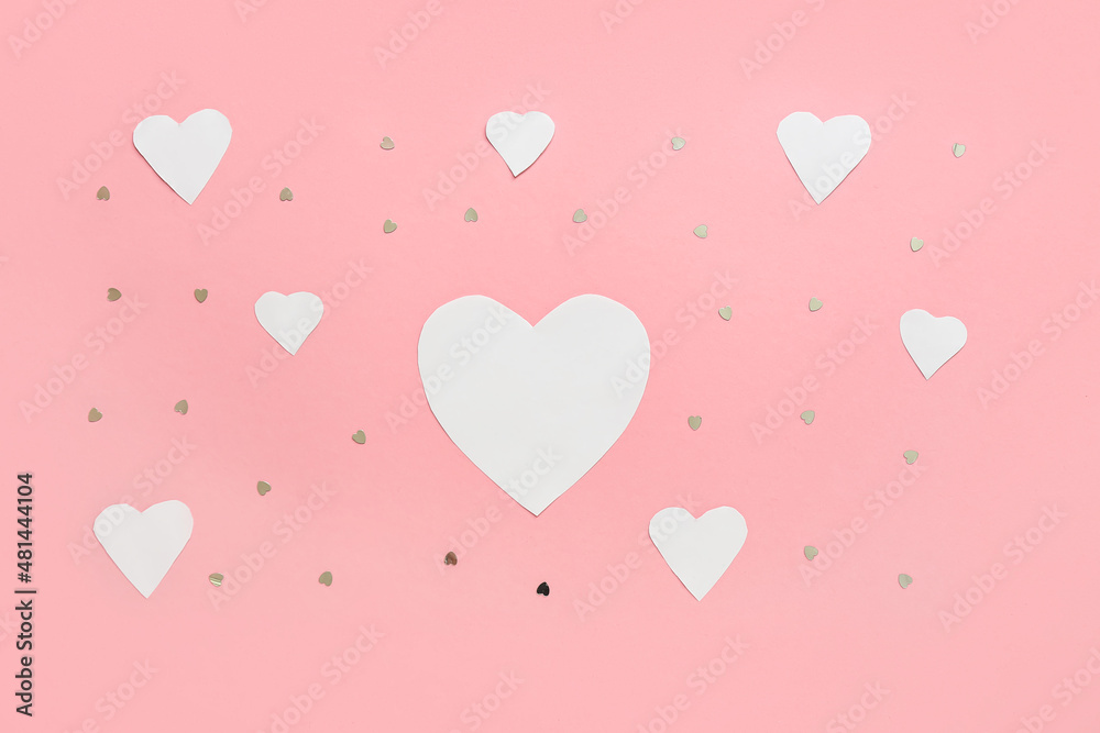 Beautiful paper hearts and confetti on pink background. St. Valentine's Day