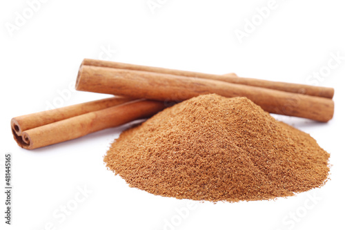 Cinnamon powder and sticks isolated on white background