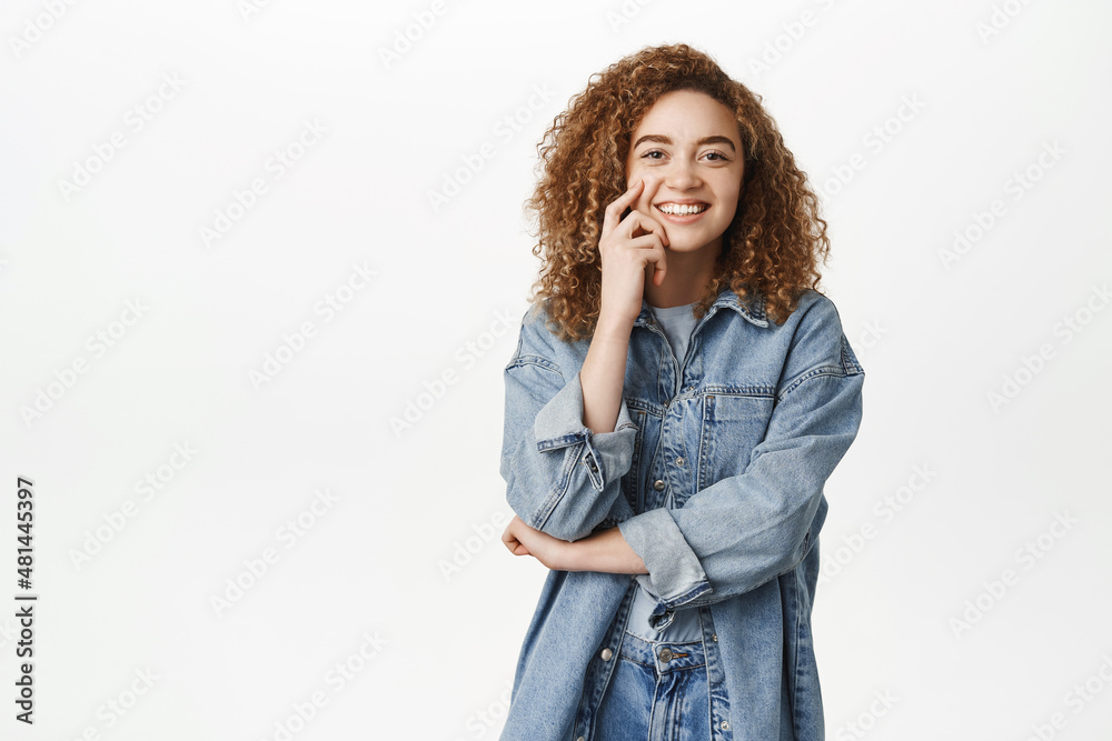 Portrait of cheerful curly young woman, laughing and smiling, looking at camera with happy face, concept of modern people and lifestyle Portrait of cheerful curly young woman, laughing and smiling, looking at camera with happy face, concept of modern people and lifestyle