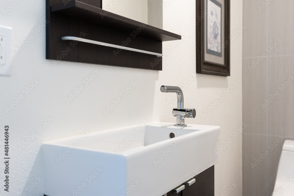 Detail of slim bathroom sink with faucet on right side. Detail of slim bathroom sink with faucet on right side.