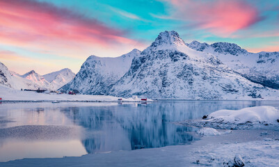 Calm winter sunrise over polar circle. Splendid morning scene of Boosen fjord on Flakstadoya island, Lofoten islands with Hustinden mountain on background, Norway,  Beautiful winter scenery