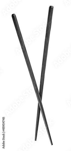 Black wooden chopsticks isolated on a white background, top view.