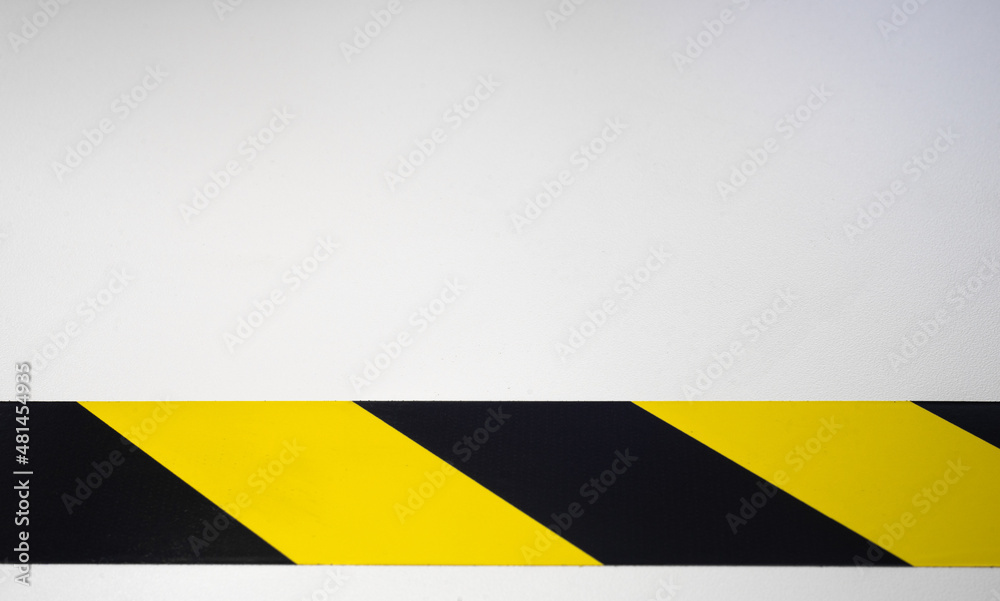 A black and yellow ribbon on a white isolate. Background with an enclosing yellow stripe.