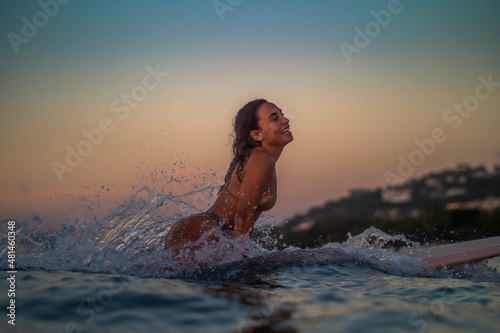 Surfing woman wave splash
