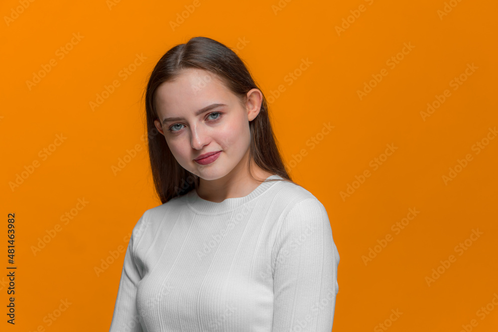 Pretty young girl with healthy smooth skin on yellow studio background. Skincare cosmetics ad, natural woman beauty Pretty young girl with healthy smooth skin on yellow studio background. Skincare cosmetics ad, natural woman beauty