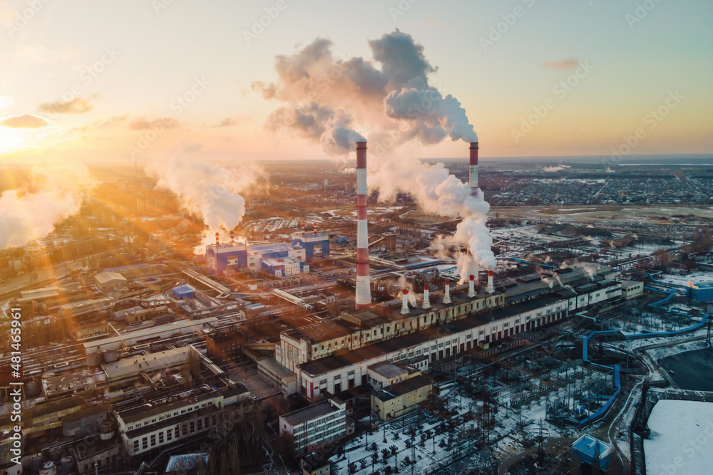Factory smokestack emissions at sunrise, climate change and global warming for the environment. Aerial view
