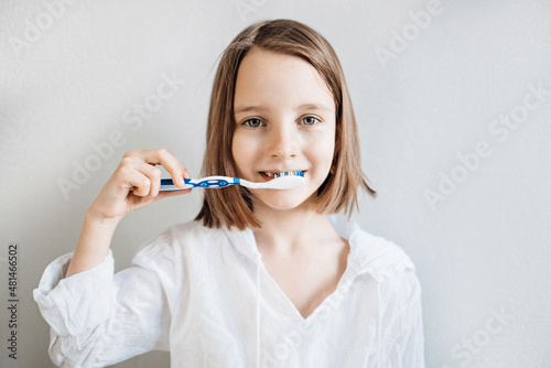 Girl brushes her teeth  dental care since childhood  a visit to the dentist