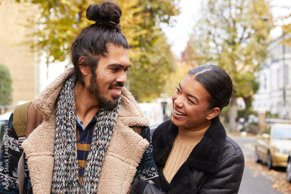 Couple walking down street in autumn Couple walking down street in autumn