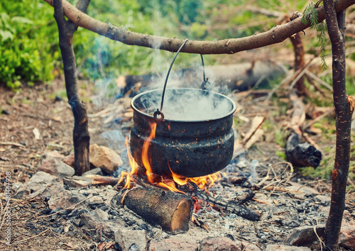 Cooking in field conditions, boiling pot at the campfire