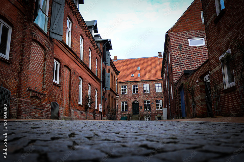 narrow street with old buildings in North Germany narrow street with old buildings in North Germany