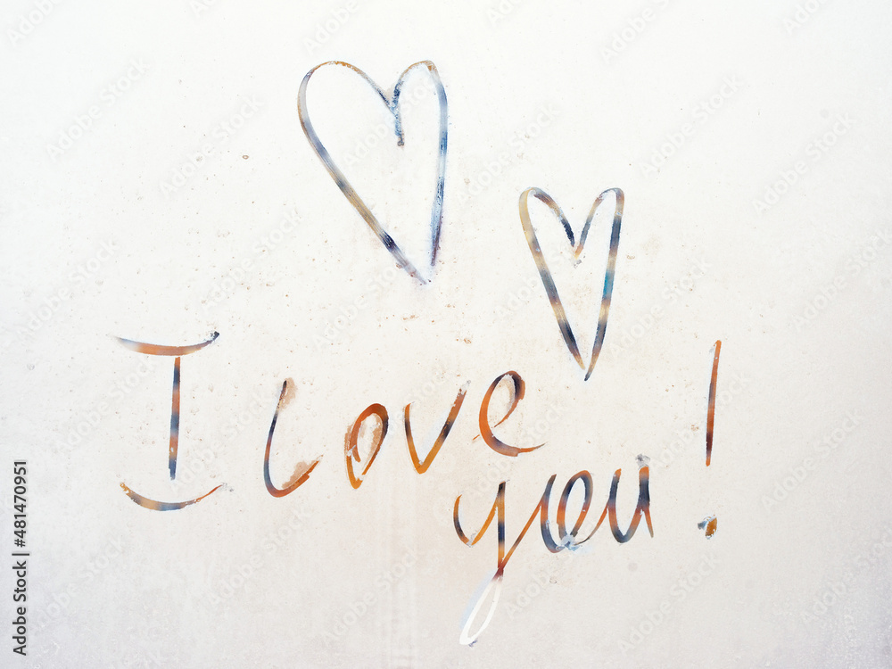 Two hearts and the inscription I love you, hand-painted with frost on a frozen window pane on a sunny day. Romantic background for Valentine's Day Two hearts and the inscription I love you, hand-painted with frost on a frozen window pane on a sunny day. Romantic background for Valentine's Day