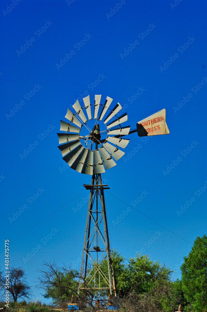 Traditional windmill for pumping water in the outback of South Australia, against a clear blue sky Traditional windmill for pumping water in the outback of South Australia, against a clear blue sky
