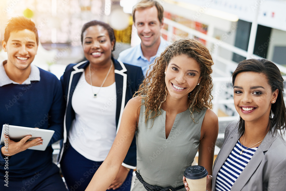 They put the positive in positivity. Portrait of a group of smiling businesspeople standing together in a modern office. They put the positive in positivity. Portrait of a group of smiling businesspeople standing together in a modern office.