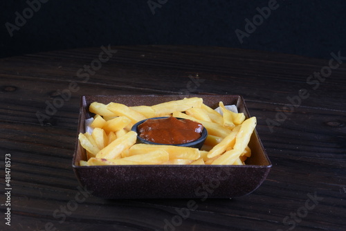 french fries with red spicy sauce isolated on the table, snack