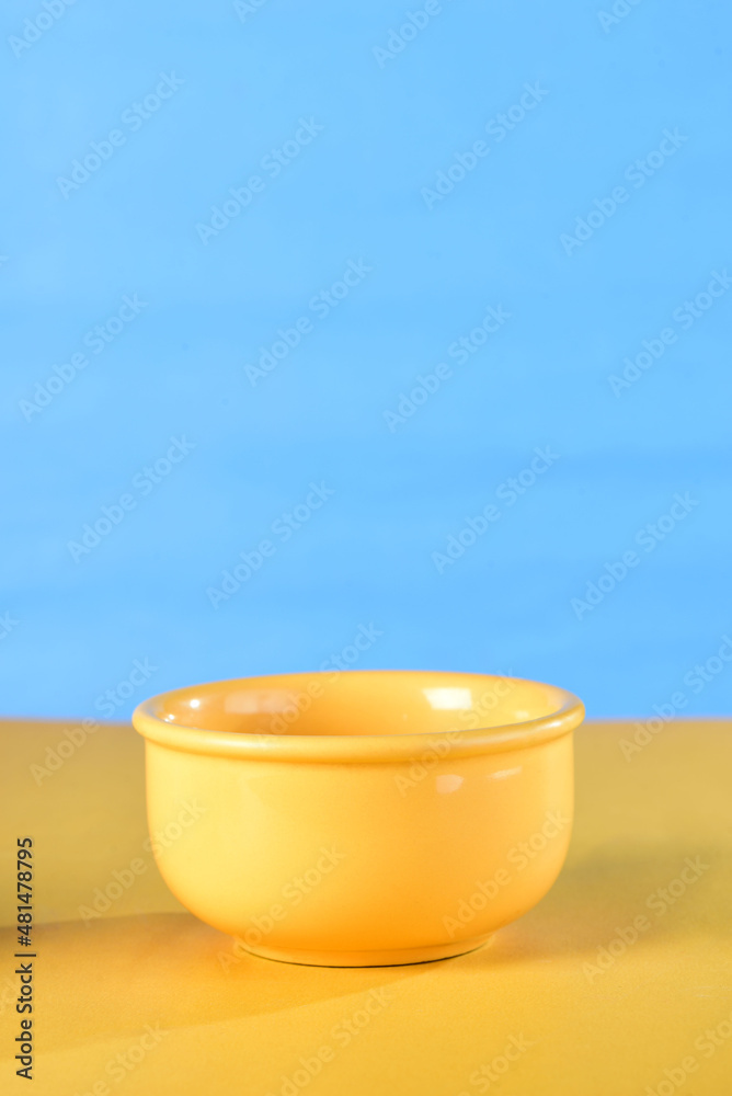 yellow porcelain bowl isolated on blue background with yellow yellow porcelain bowl isolated on blue background with yellow