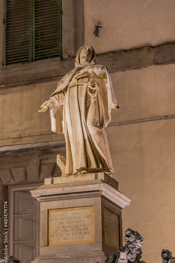 Fototapeta premium Marble statue of Santa Margherita in the square of Cortona in front of the church. The Saint, proclaimed Co-patroness of Cortona together with San Marco. Cortona Tuscany Italy