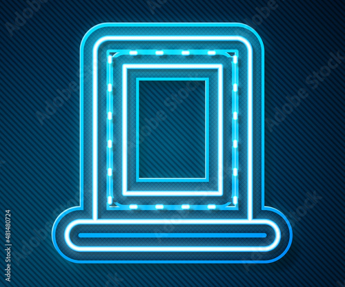 Glowing neon line Makeup mirror with lights icon isolated on blue background. Vector