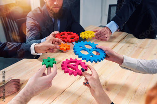 Business team connect pieces of gears like a teamwork and partners