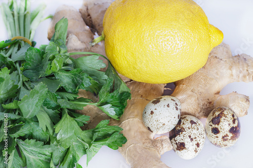 ginger root with parsley lemon and quail eggs close-up