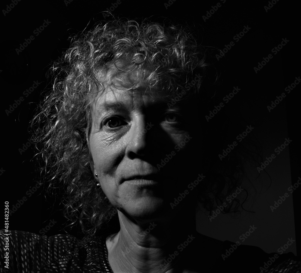 Close up portrait of middle aged caucasian woman with curly hair. Black and white. Close up portrait of middle aged caucasian woman with curly hair. Black and white.