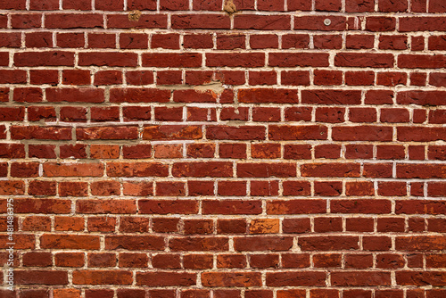 Full frame shot of a weathered old red brick wall with white joints, suitable as a background texture not only for architectural or historic topics