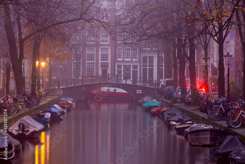 Photography Beautiful old houses on the city embankment of Amsterdam in the fog