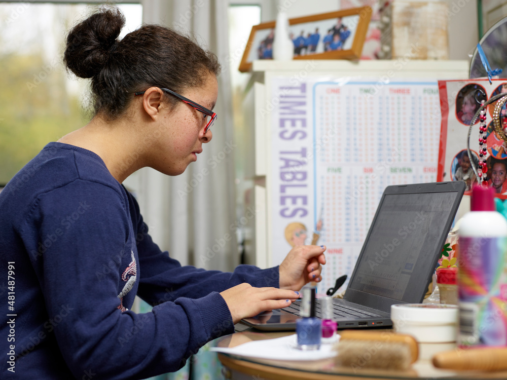 Girl with Down syndrome using laptop Girl with Down syndrome using laptop