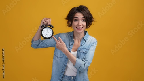 Impatient lady point bell fast hurry overtime isolated shine color background photo