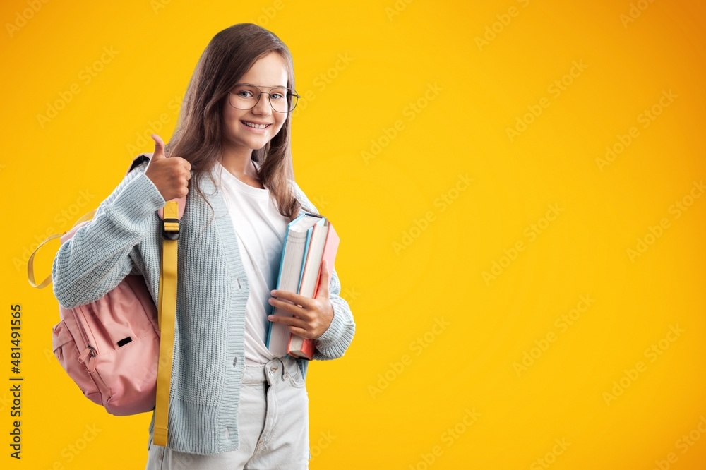 Young happy smart teenager schoolgirl pupil student wearing bag going back to school Young happy smart teenager schoolgirl pupil student wearing bag going back to school