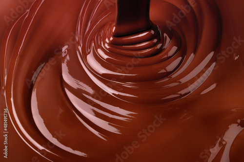 melt dark chocolate background. pour liquid cocoa dessert