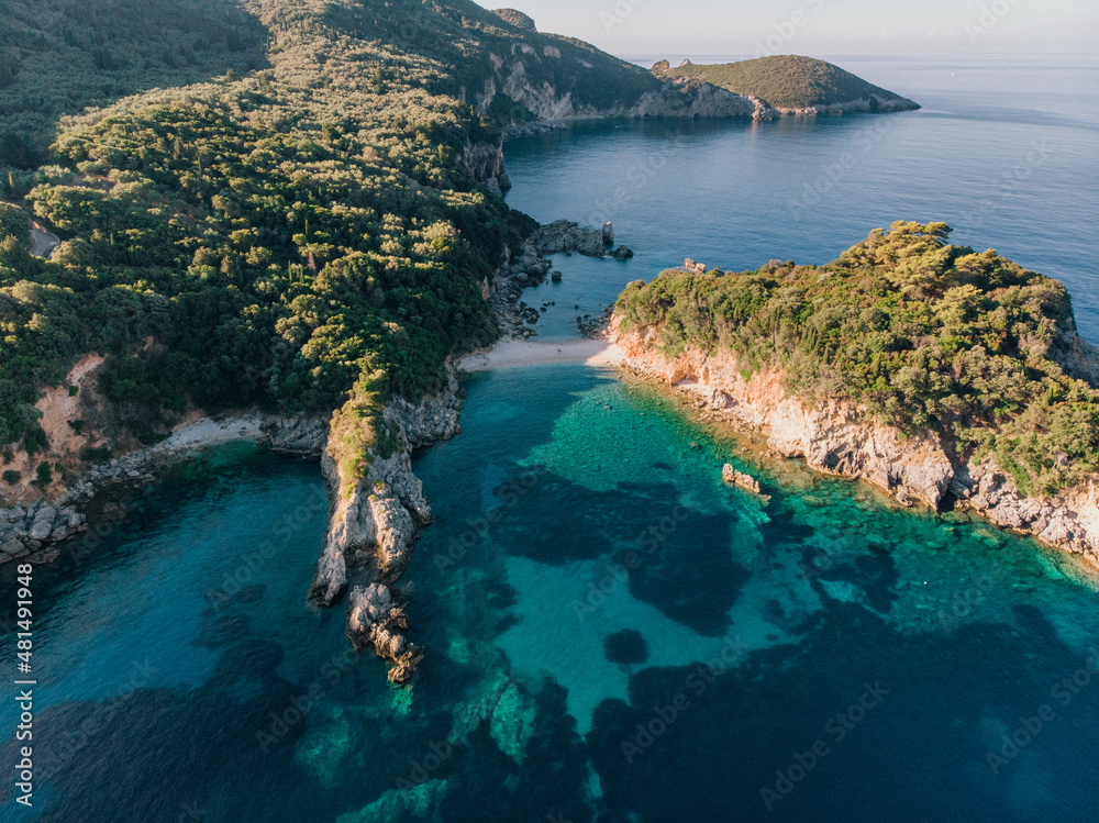 Aerial view of Corfu island. Blue lagoon is flooded with sunlight.