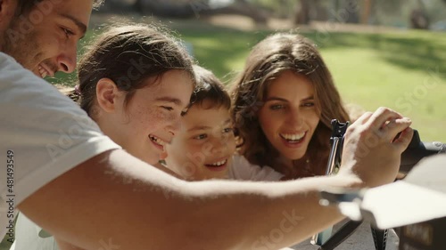 A happy family is excited at the park enjoying their monocular telescope. Close up