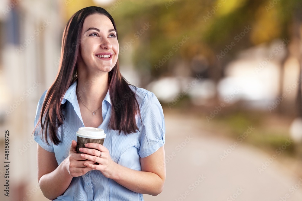 Joyful young lady posing with glass of aromatic coffee