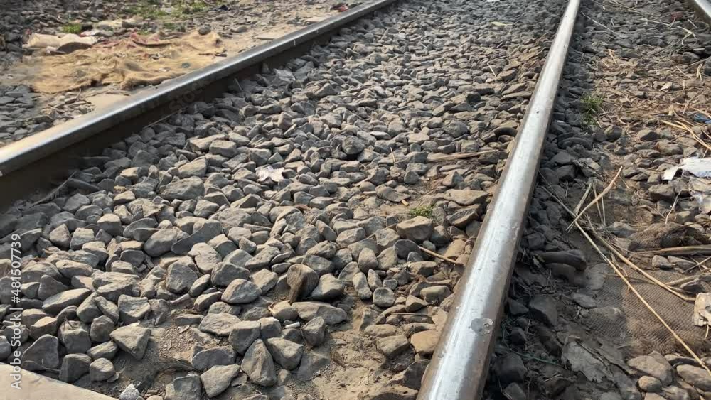 Mouse lying dead on the rail track after been hit by a train and a local meat market by the side of the tracks in Dhaka, Bangladesh. View from right to left