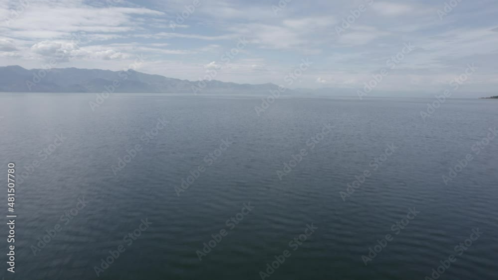 Video with a drone over Lake Skadar in Albania, descriptive frontal plane ascending from the water to reach height, with the horizon of the mountains of Montenegro. Video with a drone over Lake Skadar in Albania, descriptive frontal plane ascending from the water to reach height, with the horizon of the mountains of Montenegro.