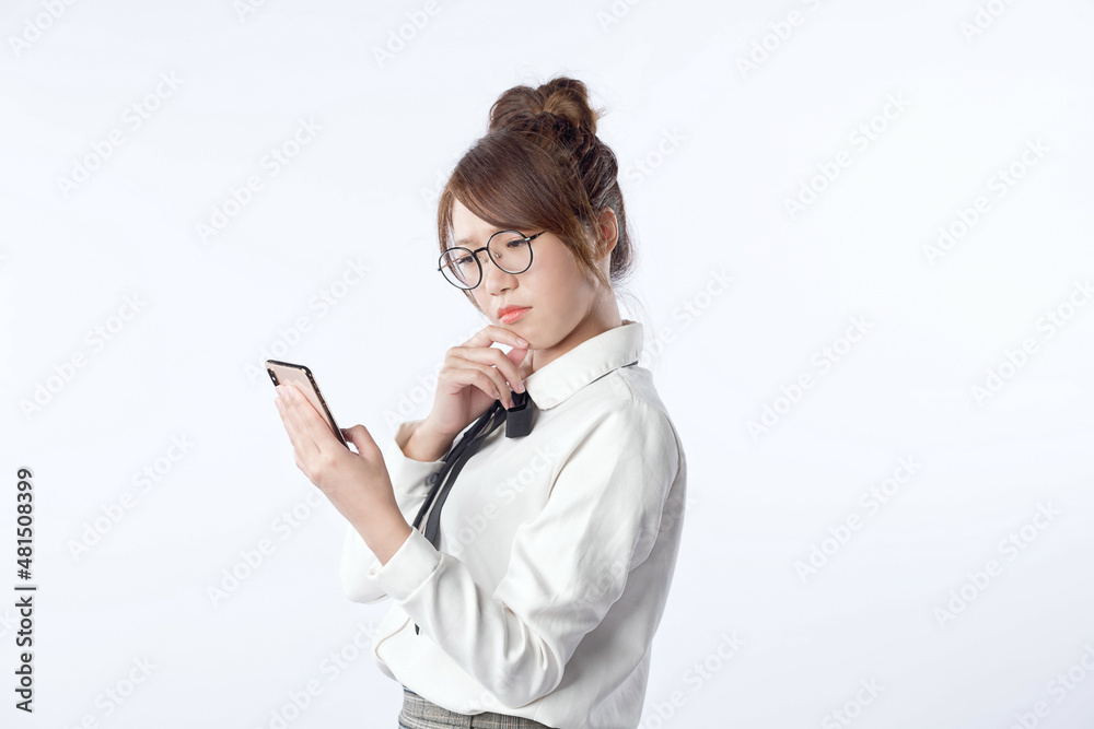 Portrait of a young girl who is holding a cell phone and worry about something with isolated white background. Negative human emotion face expression feeling. Portrait of a young girl who is holding a cell phone and worry about something with isolated white background. Negative human emotion face expression feeling.