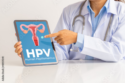 HPV (Human Papillomavirus) Female doctor explaining knowledge and pointed out women health problems on tablet screen, viruses Some strains infect genitals and can cause cervical cancer.