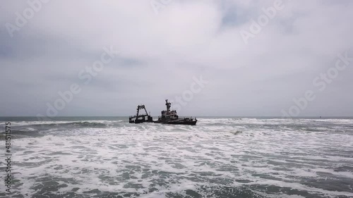 Sunken trawler, shipwreck. Old rusty metal ship Zeila at Skeleton Coast Namibia. photo