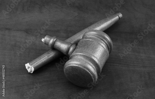 Broken wooden judge gavel on table. Concept of lawlessness, injustice and not working court.