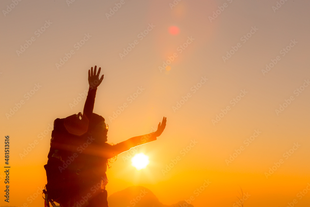 Fototapeta premium young female tourist carrying luggage at sunset
