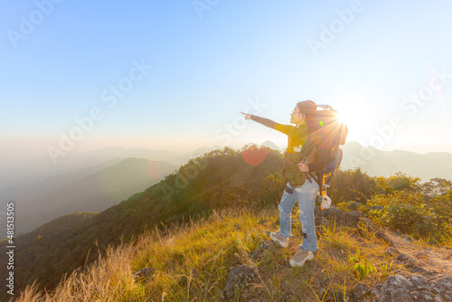 young female tourist carrying luggage at sunset