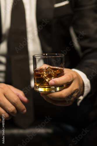 Businessmen in suits drinking whiskey