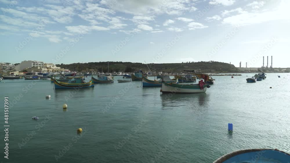 Lots of Wooden Beautiful Boats Floating in Marsaxlokk Bay on Winter Day in Malta Lots of Wooden Beautiful Boats Floating in Marsaxlokk Bay on Winter Day in Malta