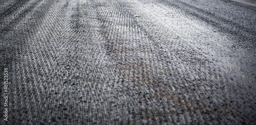 Low angle shot across a scarified street under construction with lanes on either side blocked off.