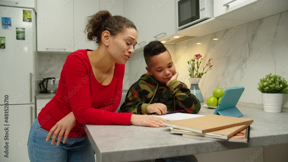Mother Becoming Frustrated With Son While Doing Homework Indoors. Stressed Woman Scolding Child for Poor Schooling at Home. Remote School Education. Tired Mom Helping Black Boy to Learn Remotely Mother Becoming Frustrated With Son While Doing Homework Indoors. Stressed Woman Scolding Child for Poor Schooling at Home. Remote School Education. Tired Mom Helping Black Boy to Learn Remotely