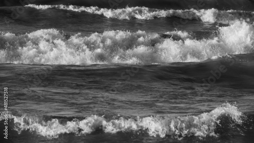 black and white image of waves of lake Ontario crashing into water on stormy day grey and white natural natire scenic horizontal format room for type backdrop background wallpaper photo