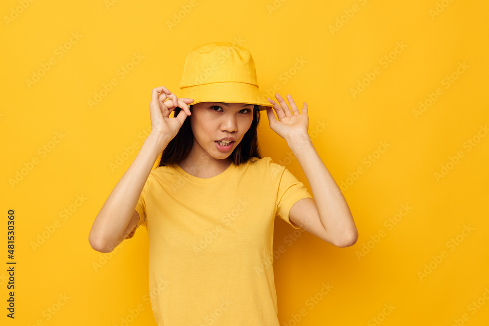 Portrait Asian beautiful young woman in a yellow t-shirt and hat posing emotions Lifestyle unaltered