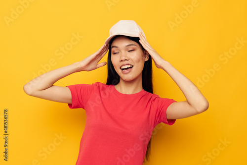 pretty brunette in a red t-shirt with a cap on her head © Tatiana