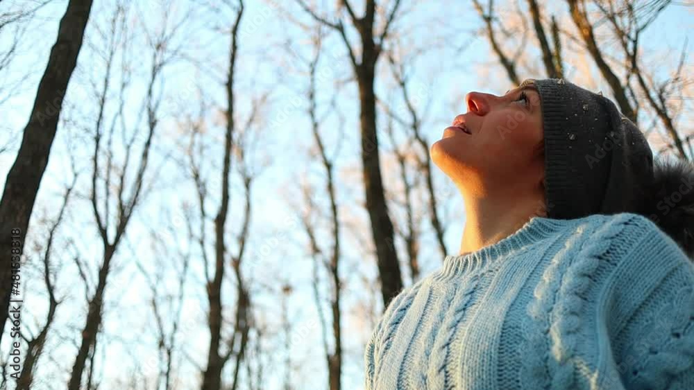 caucasian girl takes off her hat revealing red hair, sunset slow motion shot in the woods caucasian girl takes off her hat revealing red hair, sunset slow motion shot in the woods